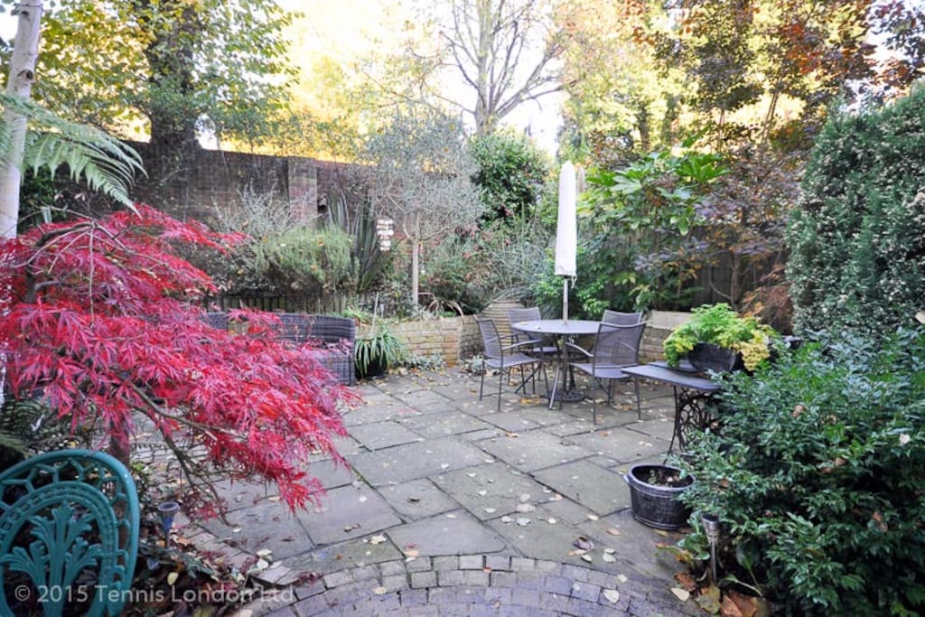 Picturesque garden with an outdoor seating area and water feature