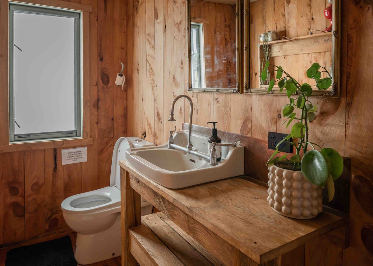 Bathroom all handmade with local wood and recycled old doctors hand basin at Lone Oak Eco Cabin in Okoroire