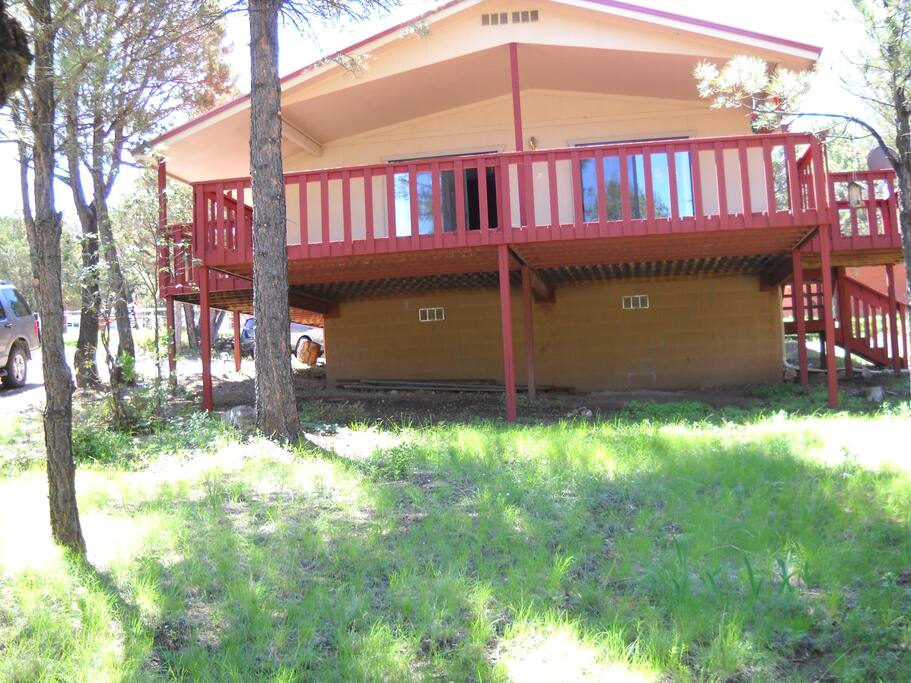 large porch on which to relax and enjoy the pine tree view