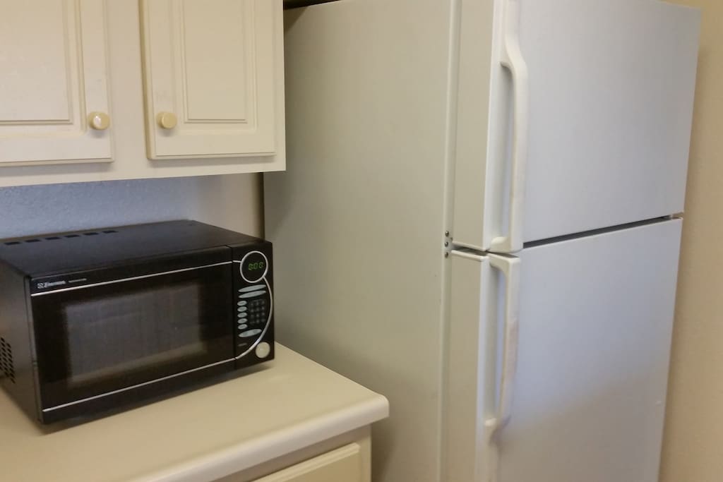 Kitchen with stove, oven, microwave and fridge.