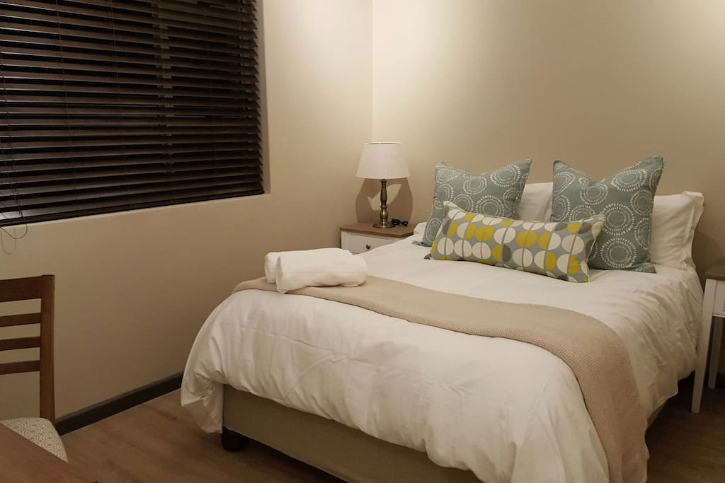 bedroom 2 with a double bed and an en-suite bathroom and TV.