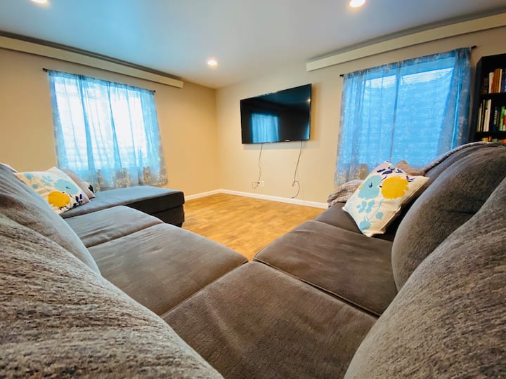 Sitting area with large sectional and Samsung 65” Smart TV w/ HDMI