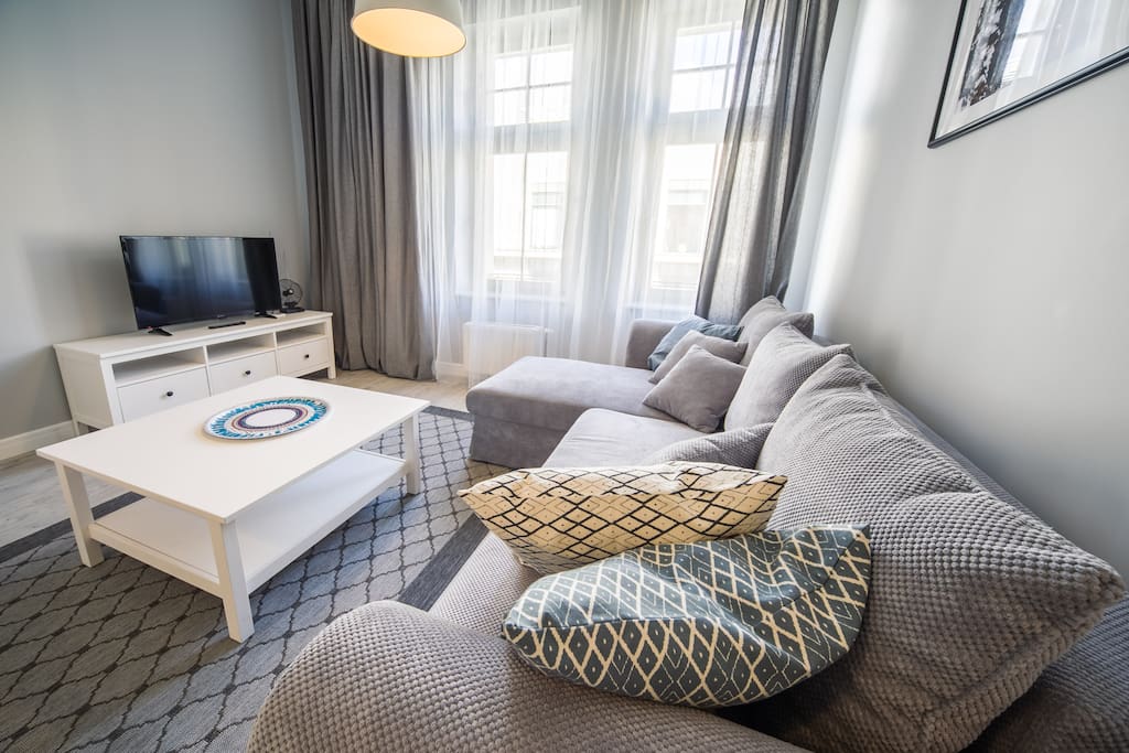 Living room with sofa, coffee table and flat screen TV