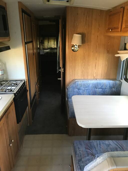 Kitchen and table that turns into a bed. In the back is the bedroom and bathroom