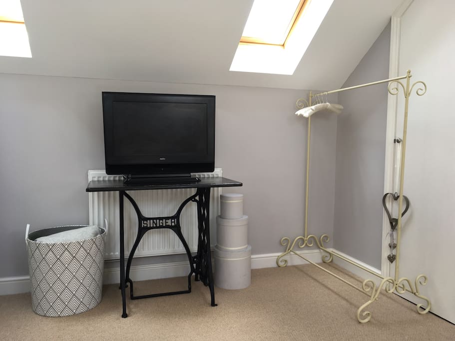 TV for Chromecast. Hanging rail for your clothes. Basket with an extra quilt and soft lambswool blanket.