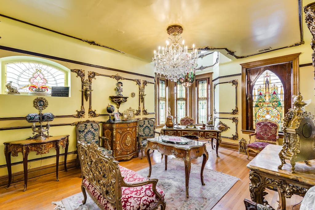 The front parlor has countless antiques and a gorgeous chandelier