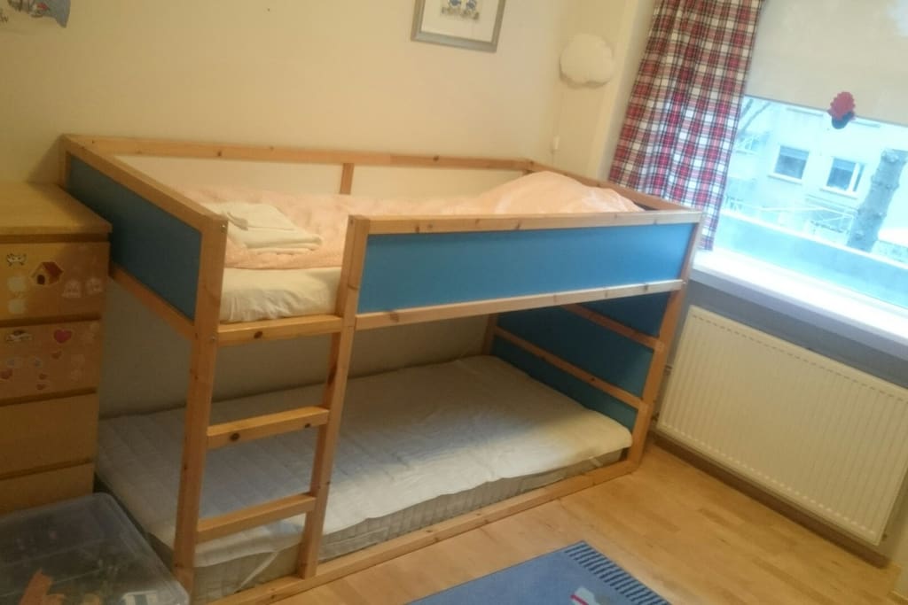 Children's room with bunk bed and floor mattress.