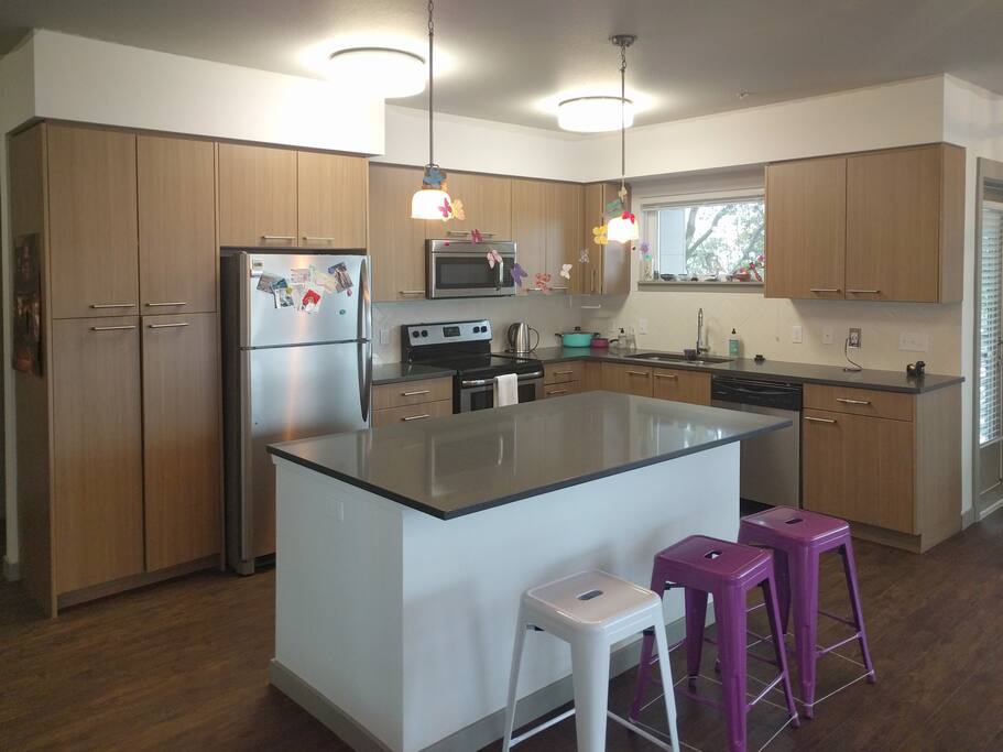larger kitchen - plates, bowls, silverware, coffee, tea, toaster, counter top appliances, pots, pans, baking supplies, and basic supplies are all provided