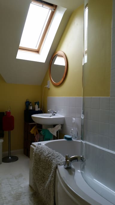 Bathroom showing window, sink, mirror, power point.