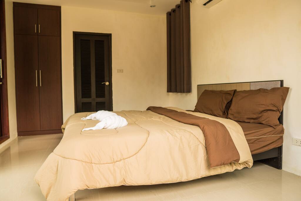 First bedroom, large king sized bed and attached bathroom