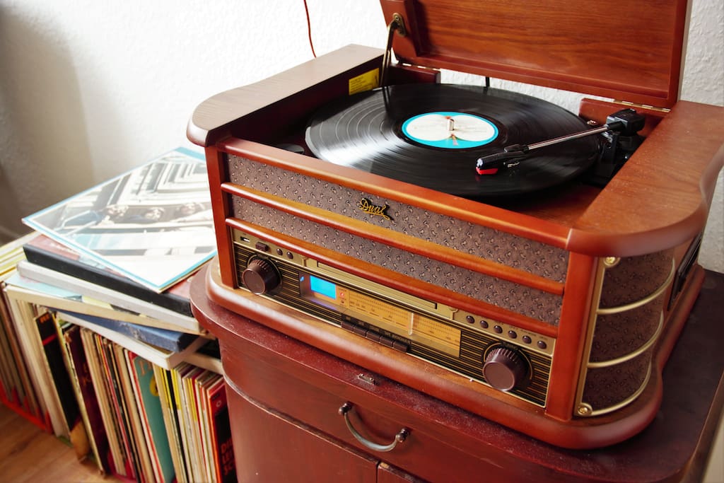 a record player together with vinyl collection,
