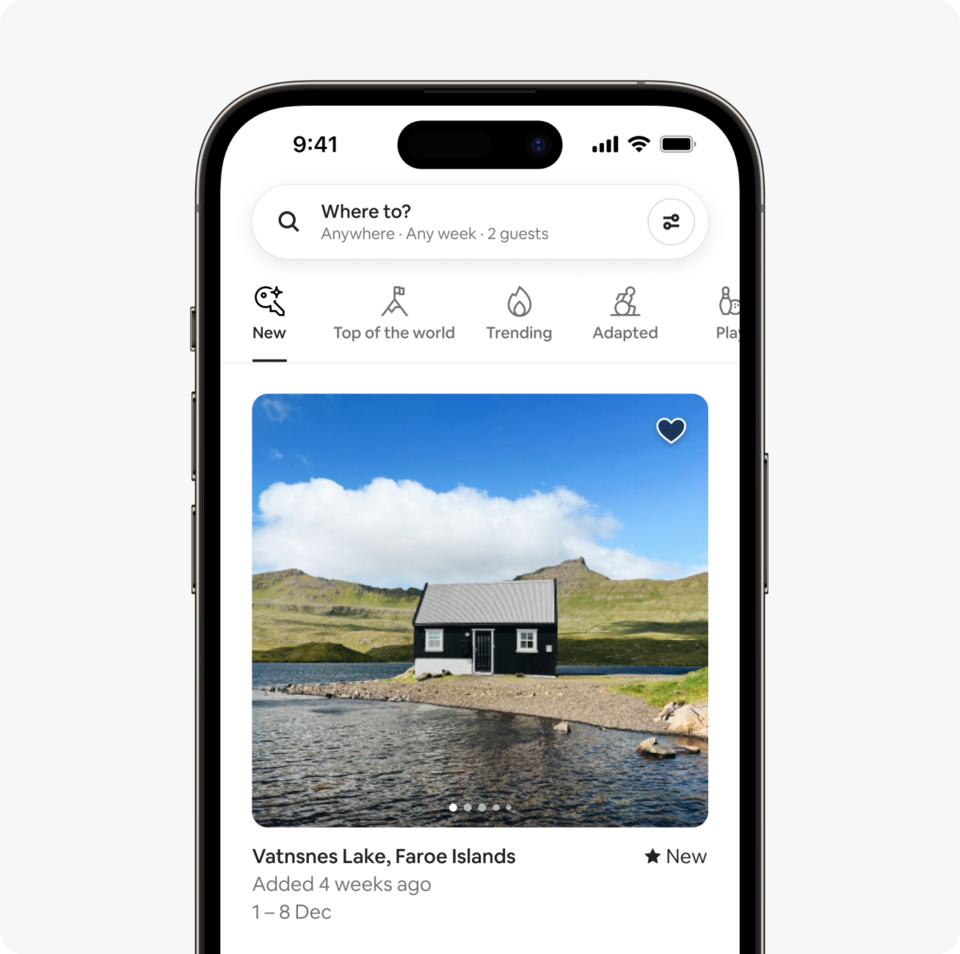 A laptop and a phone show the Airbnb homepage with two rows of homes from a new Airbnb November Release category called New, which features homes added to Airbnb within the past 10 weeks.