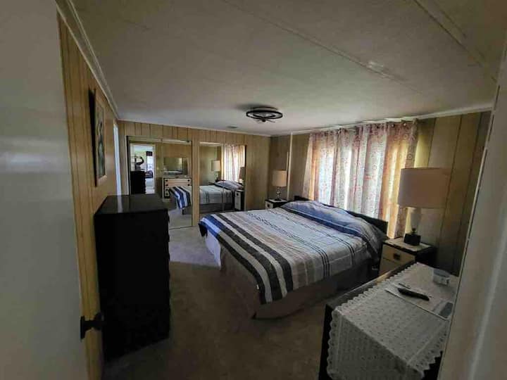 חדר שינה ראשי עם מיטת קינג סייז ואמבטיה פרטית מלאה.