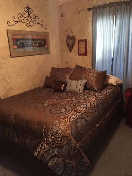 Guest bedroom with queen size bed. Playpen and toddler bed available upon request. If you need noise to sleep there are box fans in both rooms