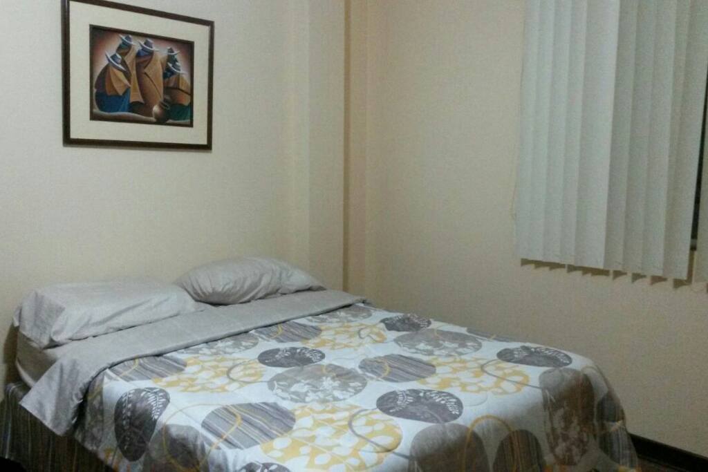 Master bedroom with own Tv in front of the bed.