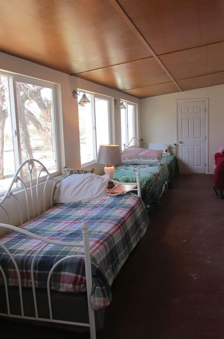 Three twin beds with Pop-up Trundle Beds sleep 6 adults. Bedroom 4 / West Veranda