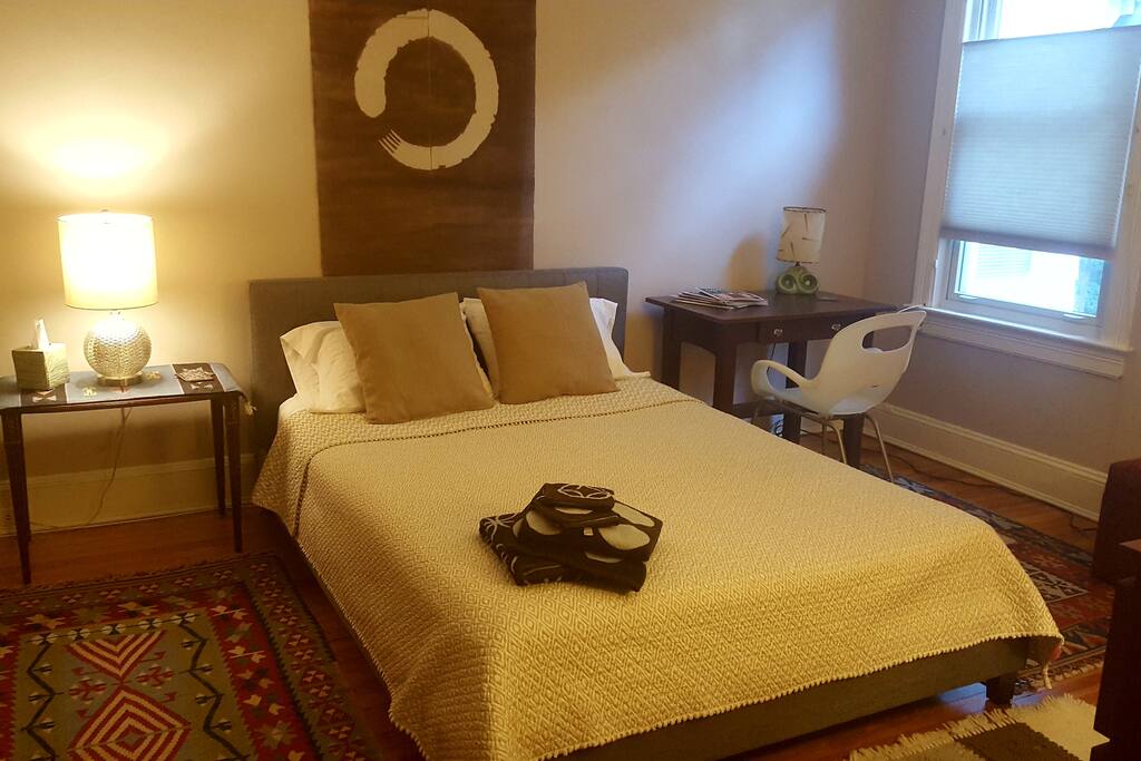 Spacious guest bedroom with queen platform bed and good all-cotton sheets.