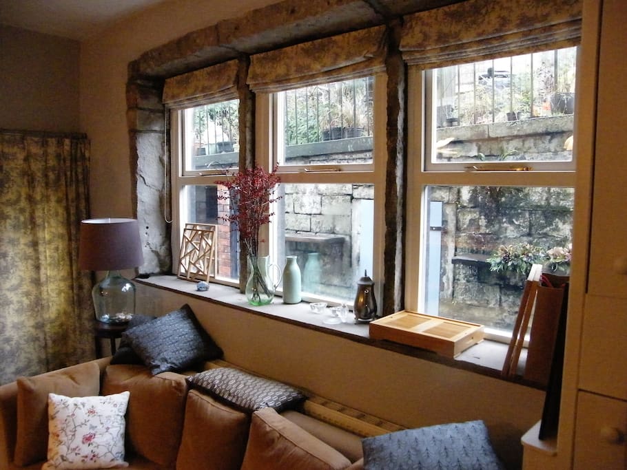 Large & cosy couch under the stone mullion windows