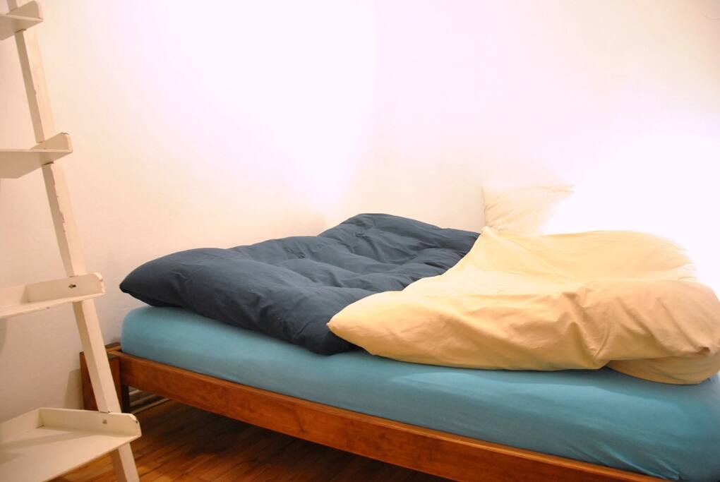 sleeping room with one king-size bed, storage space and two windows (one small window facing the inner courtyard)