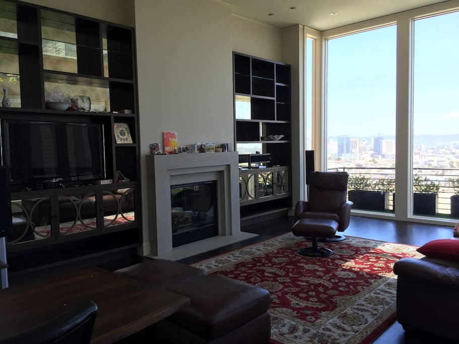 The living room has a beautiful fireplace that is perfect for relaxing and looking at the view. The sofa folds out into a queen size bed for additional guests.