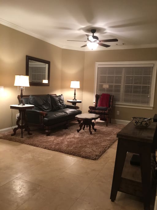 Comfortable leather loveseat and reading chair on a soft shag rug. Read or watch TV in your home away from home.