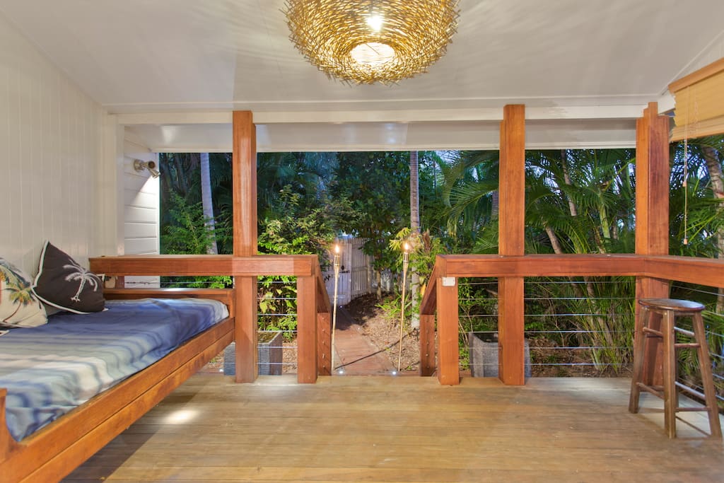 Relax outside on the day bed and enjoy the privacy of the palm trees