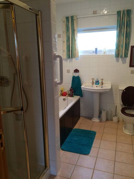 Shared bathroom with bath and separate shower.