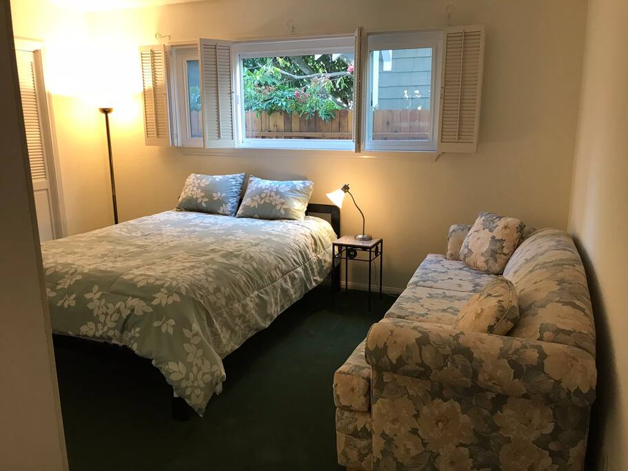 Queen Bed and Couch in Furnished Guest Room