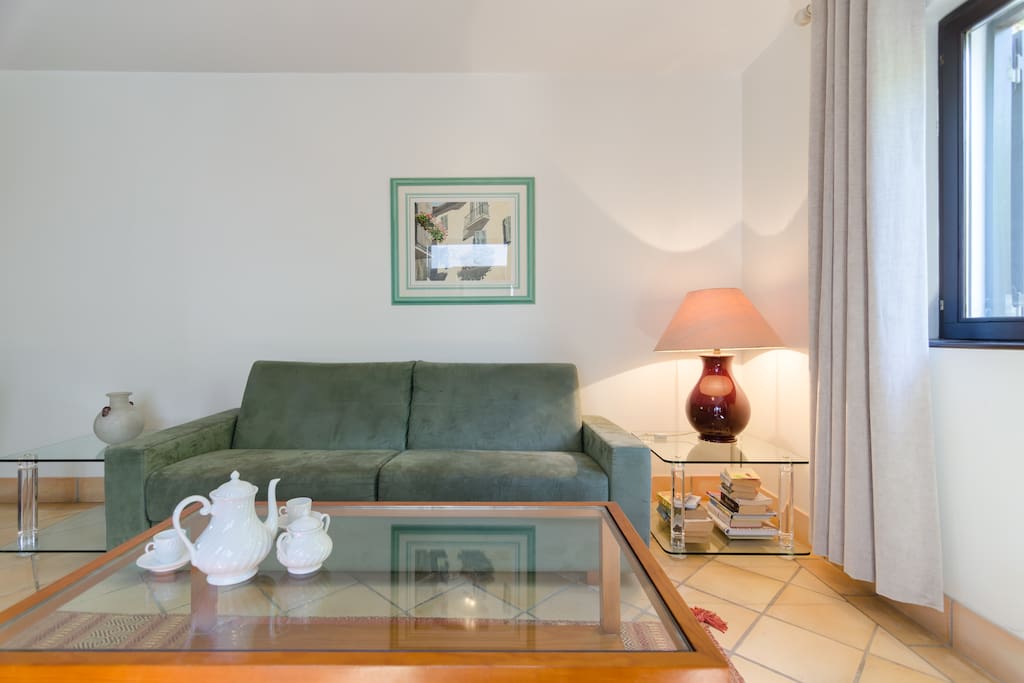 Lounge with double doors leading to the balcony with BBQ and out door furniture