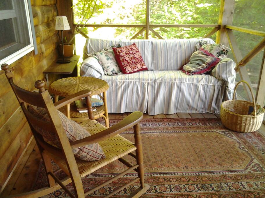 The porch feels like a tree house amid the white pines.