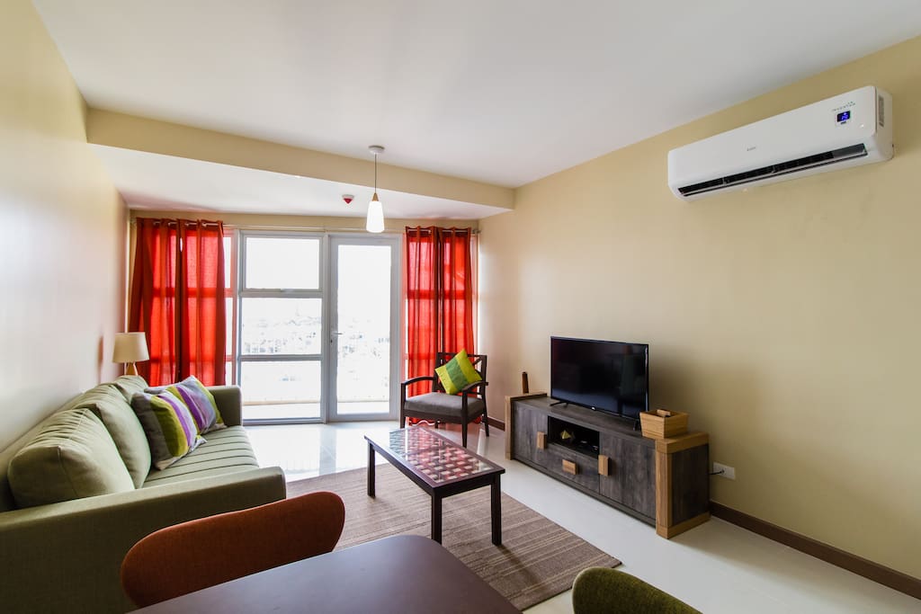 Spacious living area with a lot of natural light. The unit doesn't get hit by direct sunlight but is well lit all day