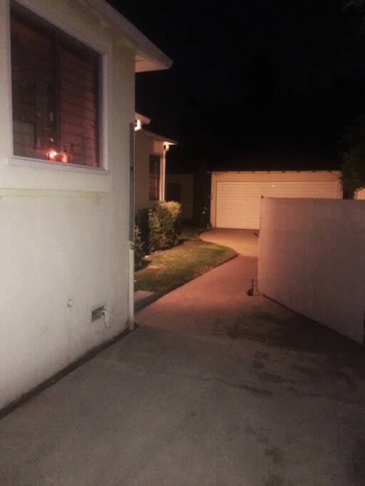 Driveway leading to private entrance & open back yard