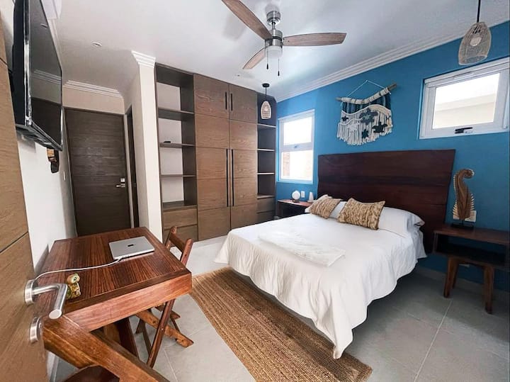 Cozy and functional: A room designed for comfort with a queen-size bed, entertainment at your fingertips with a TV, and a dedicated workspace for productivity. Your ideal sanctuary for relaxation and productivity awaits.