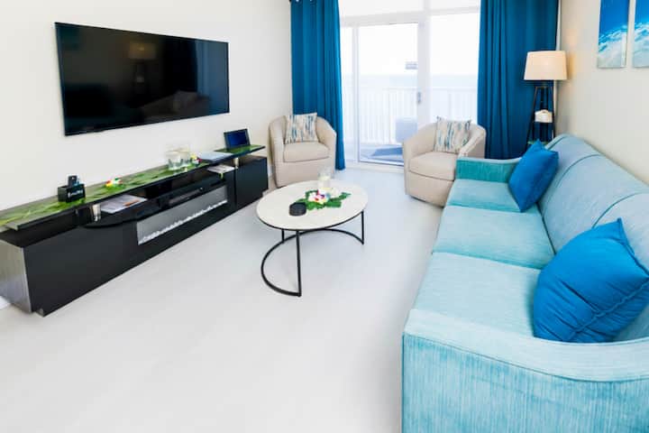 A living room with sitting to accommodate up to five people.