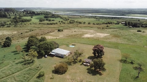 A field with a pool and river view