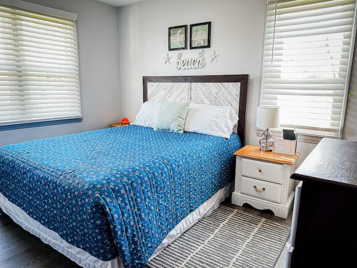 The secondary bedroom has a queen bed, closet and dresser.
