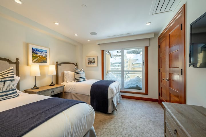601 Twin Bedroom with television, juliette balcony and views of the upper village. Separate bathroom with shower/bathtub combo