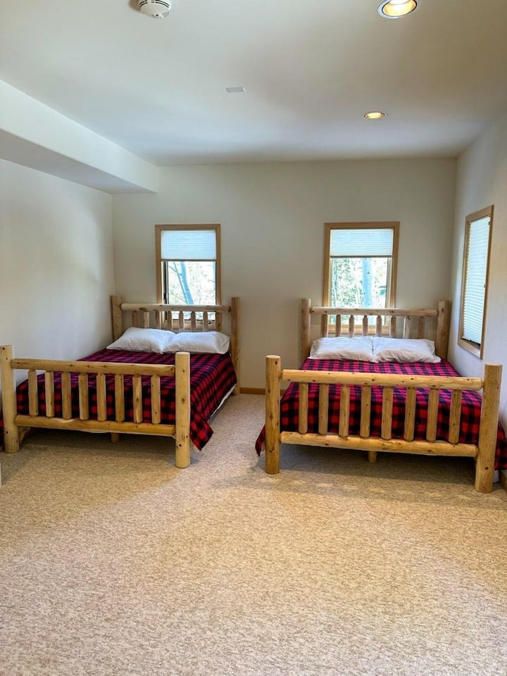 Lower floor bedroom featuring two queen size mattresses