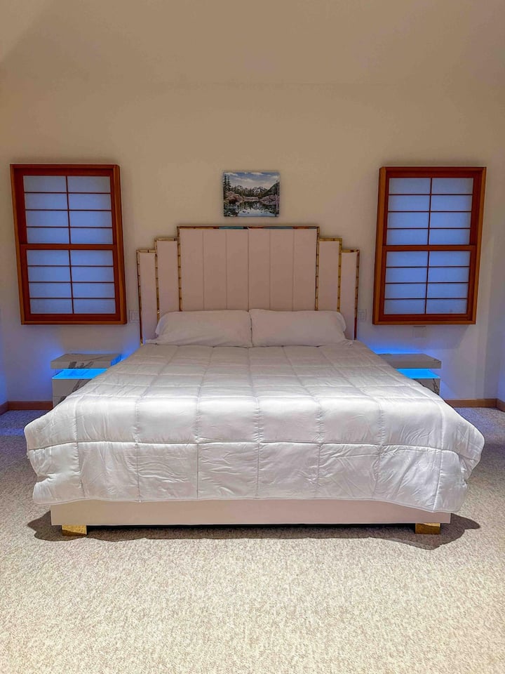 Upper floor master suite bedroom featuring a king size bed - 14” plush memory foam mattress - and unique shoji architecture windows and doors