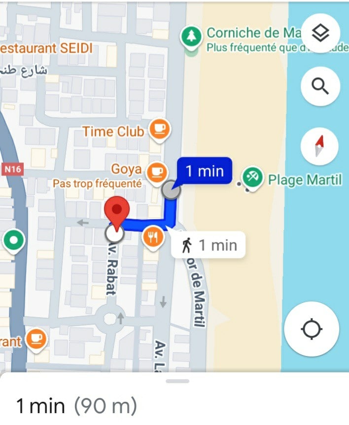 The map displays a clear layout of the area surrounding the apartment, with key points of interest highlighted. Notable locations include the beach, restaurants, and café Goya, all within a one-minute walking distance. Streets and paths are shown, emphasizing accessibility to nearby amenities.