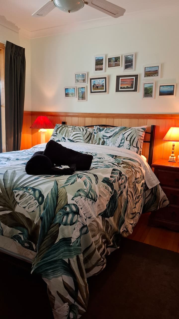This cosy room has a double bed, a wardrobe and ceiling fan.