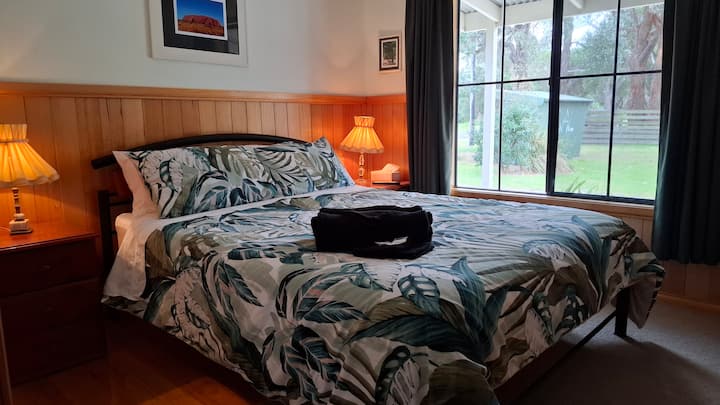 Have a peaceful night sleep in a comfortable queen bed.  The main bedroom.also has a built in wardrobe, bedside lamps, TV and ceiling fan.