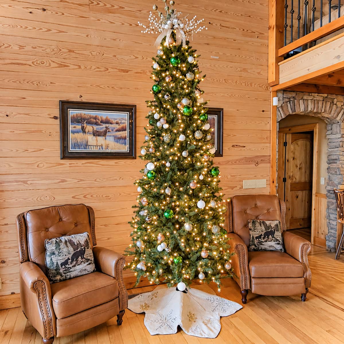 A glowing Christmas tree between two cozy leather chairs.