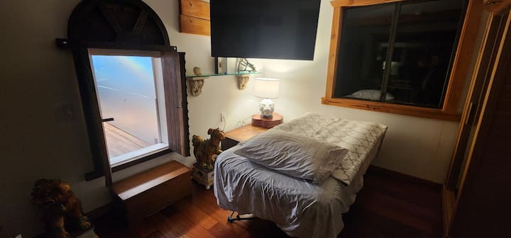Comfy cot nestled in the  secret room. 