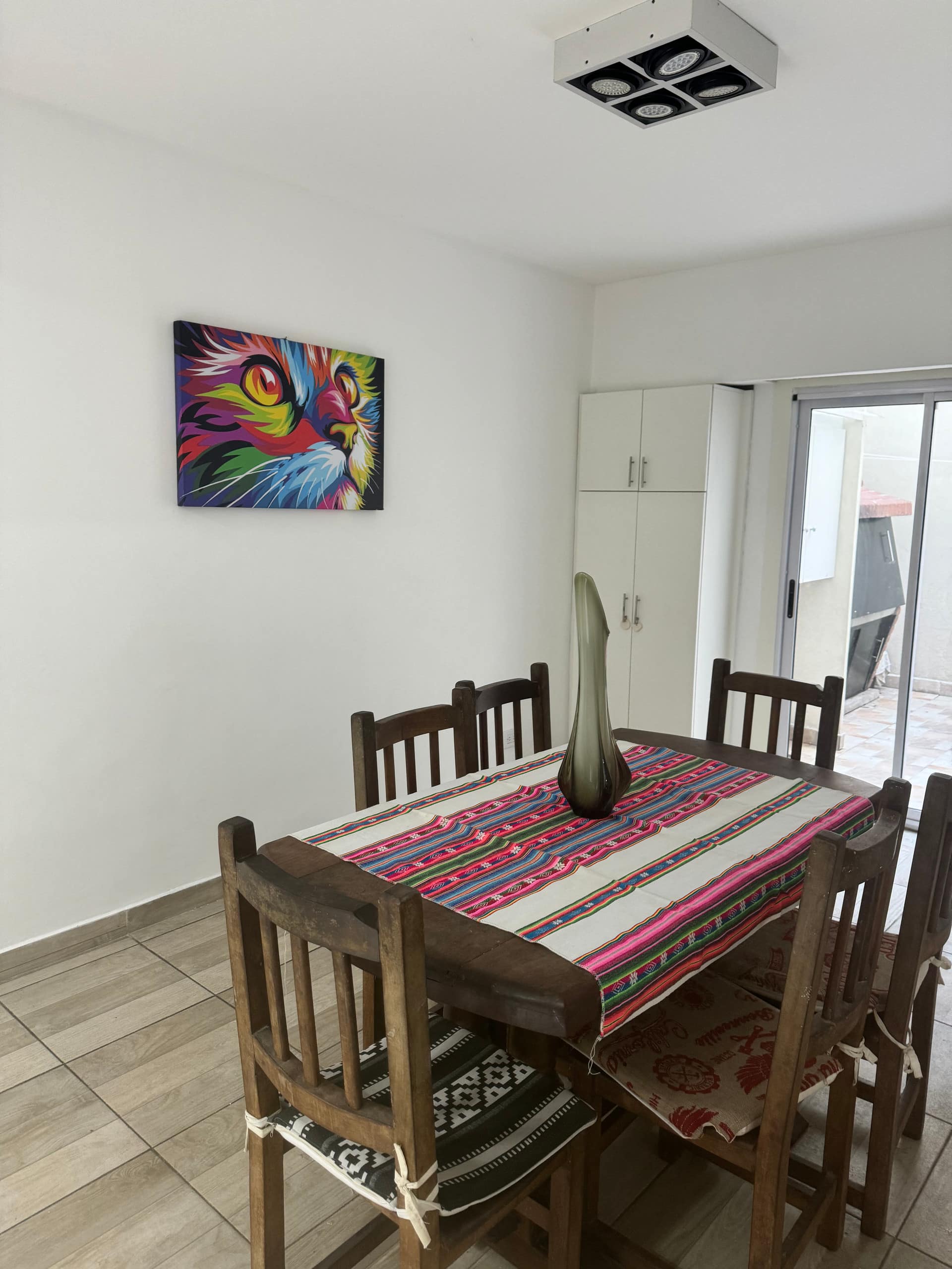 A spacious apartment with a patio and grill