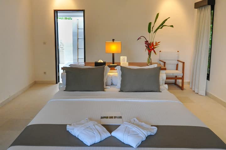 Settle into a calm and spacious bedroom where soft lighting and natural materials create an immediate sense of ease. The ensuite bathroom is just steps away, allowing you to move effortlessly between rest and refresh throughout your stay.