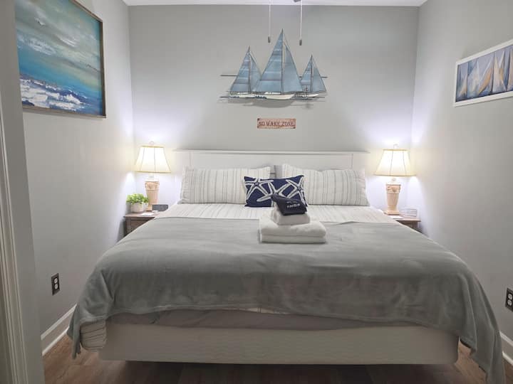 Comfortable king bedroom with lake-inspired sailing décor.