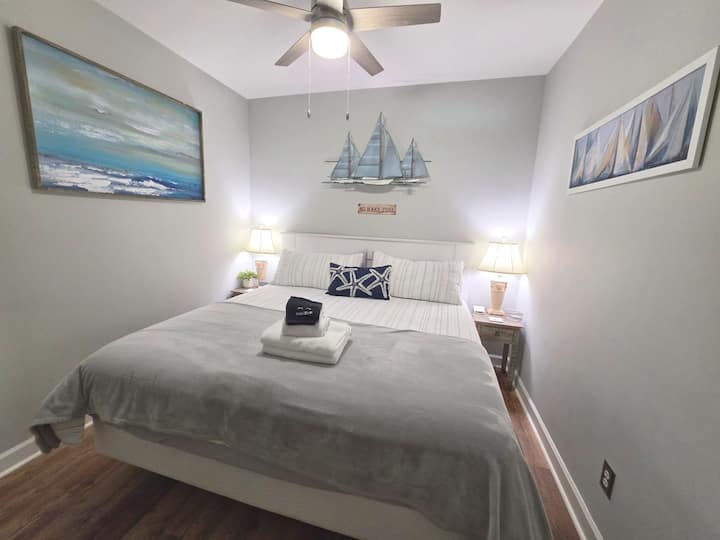 Comfortable king bedroom with lake-inspired sailing décor.