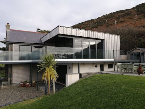 Stunning home overlooks the sea.