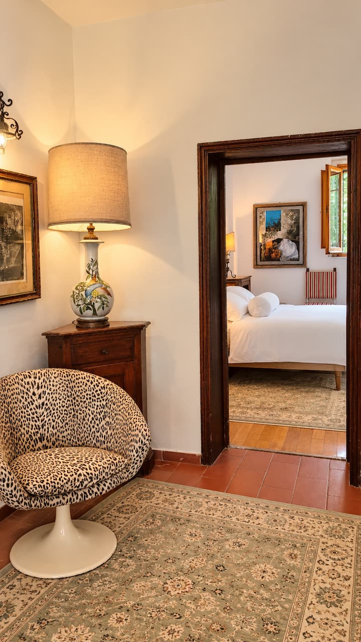 The primary bedroom is located on the 1st floor, the main level of the house. The bedroom features a sublime marble bathroom with walk-in shower, and a sitting room with sofa bed, fireplace and television. Perfect for those who can't climb stairs.